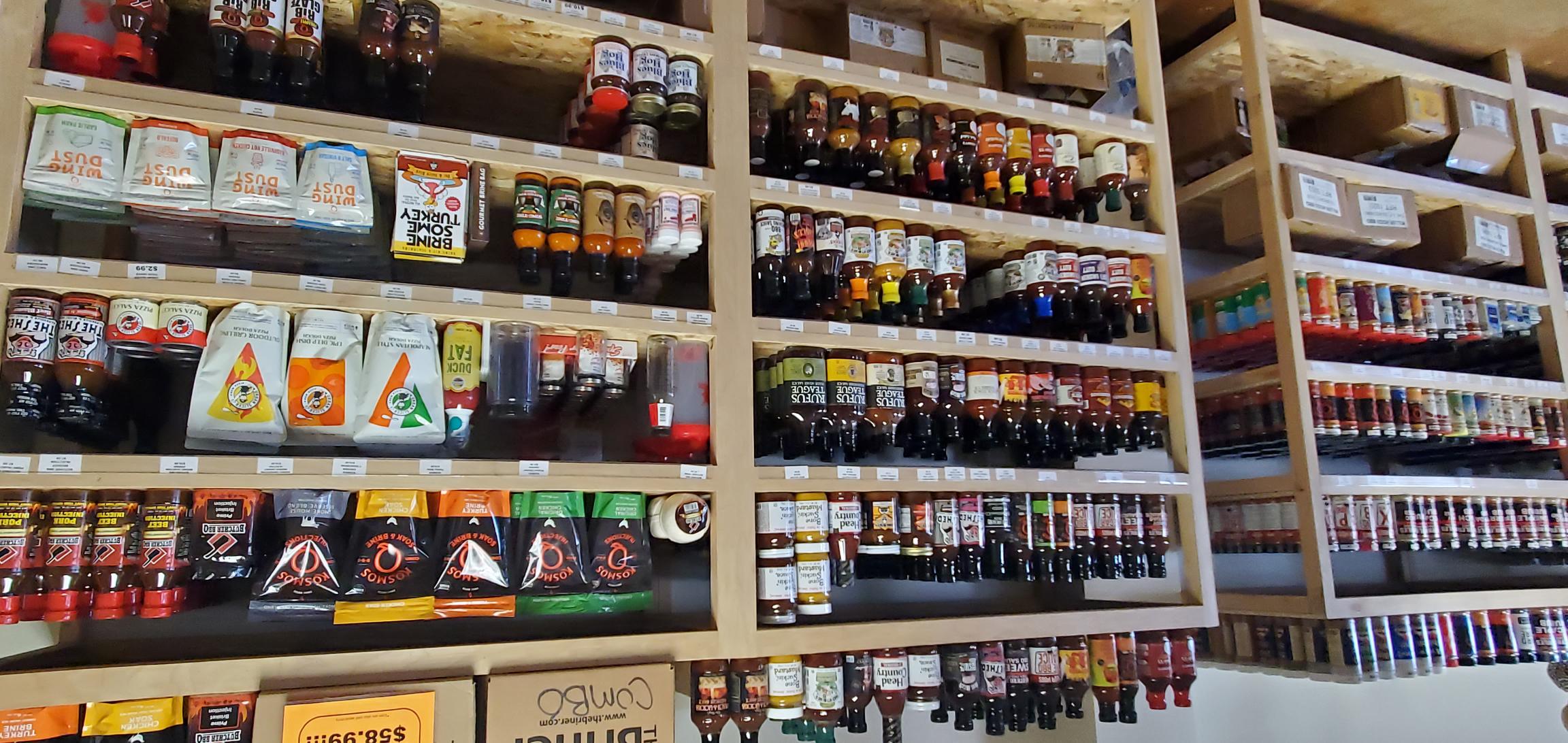 BBQ sauces and marinades on shelves at Colorado BBQ Outfitters